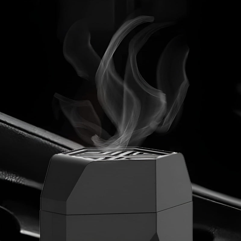 Close-up of smoke releasing from the top vent of a black electric hair bakhoor comb burner.